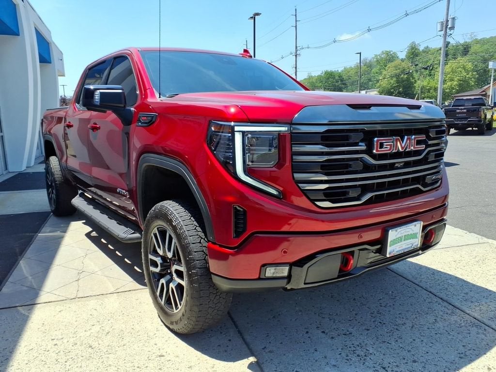 2024 GMC Sierra 1500 AT4 in Volcanic Red Tintcoat — front three-quarter view